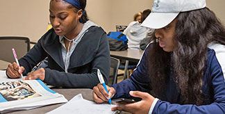 Two students studying in a classroom.