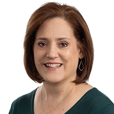 Mary Klaus smiles into the camera against a white background.