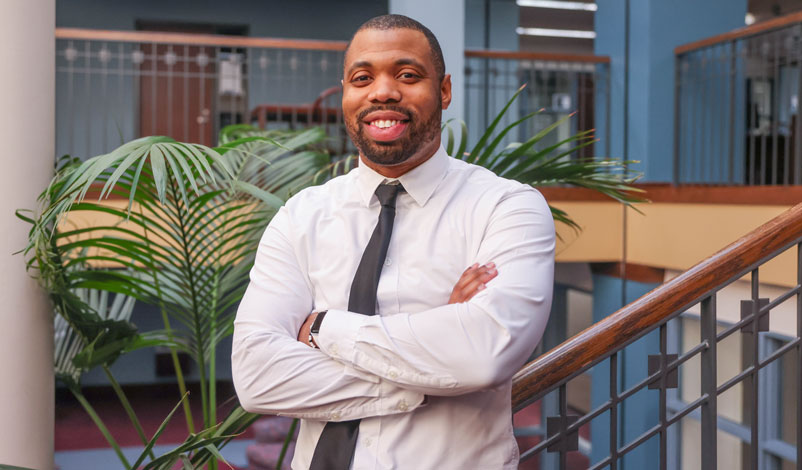 Damitri Taylor '25 MBA posing inside of Busse Library