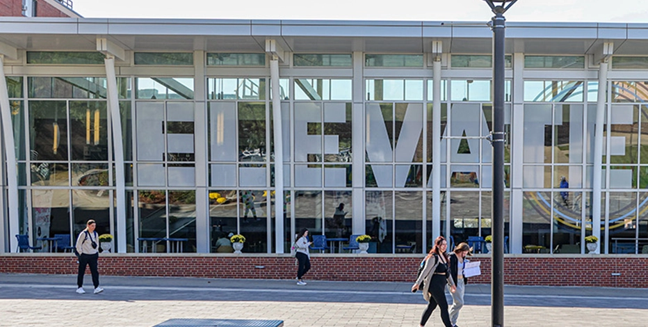 Students walk by the outside of MMU's academic buildings.